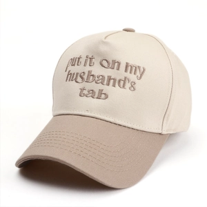 Detail of embroidered lettering on two-tone cotton baseball cap with adjustable strap