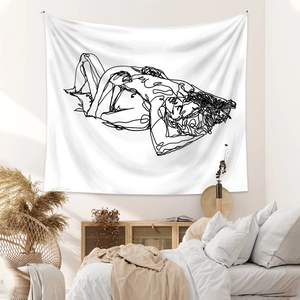 Detail of minimalist line art tapestry hanging over a bed in a modern cozy bedroom