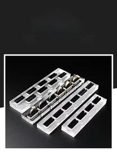 Macro view of clear acrylic ring display stands with premium black velvet slots for jewelry