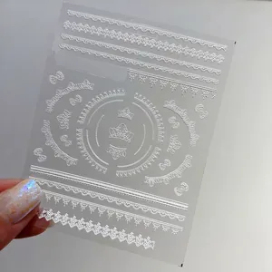 5D embossed white lace nail art stickers with crown and bow designs on high-quality sheets