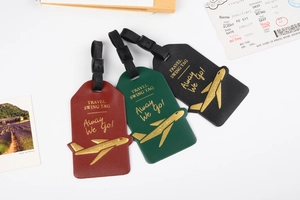 Close-up of colorful PU leather luggage tags with gold TRAVEL SWING TAG lettering