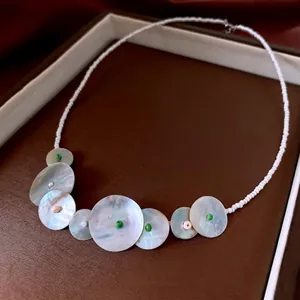 Luxurious handmade beaded necklace with shell pendants and iridescent pink quartz details
