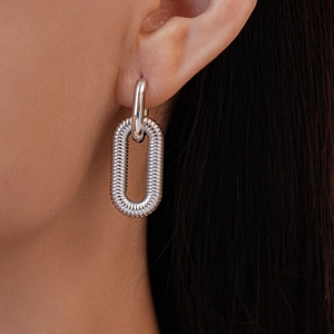 Macro shot of silver textured hoop earrings featuring a unique double-link tiered design