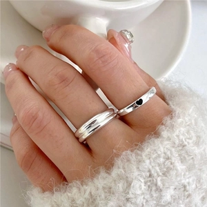 Close-up of S925 sterling silver ring set featuring a black heart charm and glossy finish