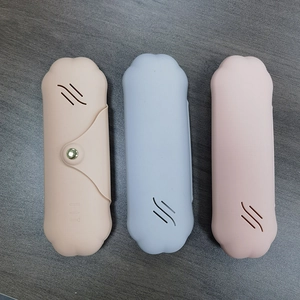 Detailed view of silicone makeup brush holders in cat paw shapes on wooden surface