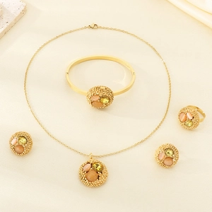 Detailed view of luxury gold-plated jewelry set with colorful stones on beige silk cloth