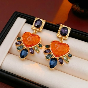 Vintage gold earrings with purple oval gems and colorful heart shaped stones in a luxury box