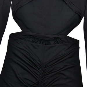 Detail of waist cutout design and elegant ruched texture on a slim-fit black maxi dress