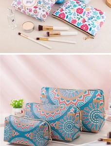 Detail view of large PU leather makeup bags with vintage floral and bohemian patterns