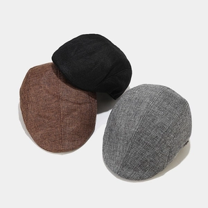 Three stacked retro newsboy caps in black, brown, and grey with breathable linen texture