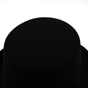 Detailed top view of a black wool felt top hat with a smooth textured finish
