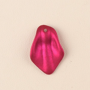Detailed macro view of magenta acrylic petal pendant with matte embossed ripple texture