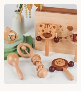Detail of wooden baby rattle set with animal shapes and natural wood texture in a box