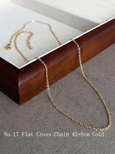 Detailed view of a 18k gold-plated flat cross chain necklace with 45+6cm length