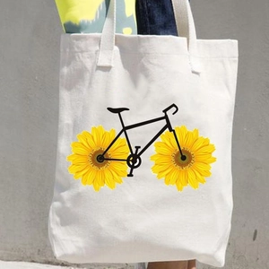 White canvas tote bag featuring sunflower bicycle silhouette print on a minimal background