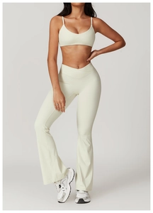 Detail of cross V-shape waistband on flared yoga pants and slim strap sports bra