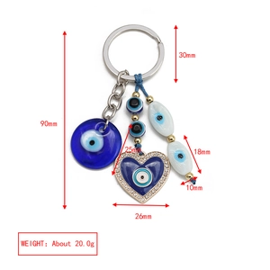 Detailed view of evil eye keychain with heart pendant and dimensions for bag charm