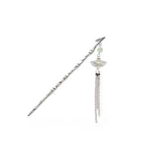 Detailed view of silver bamboo-style hair pin with jade bead and tassel pendant