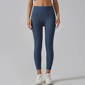 Detail view of high waisted yoga leggings with functional side pockets in blue
