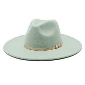 Close-up of mint green wool fedora hat featuring a thin faux leather band with gold buckle