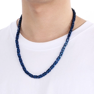Close-up of deep blue Byzantine stainless steel chain necklace worn by a male model