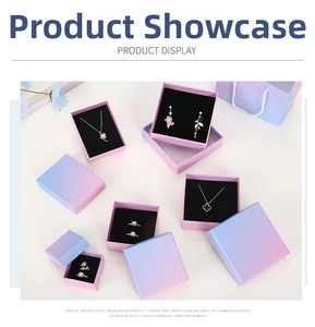 Macro shot of gradient pink and blue jewelry boxes with premium black velvet inserts