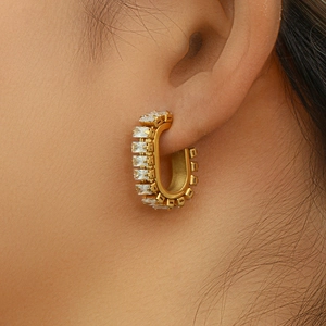 Detailed close-up of 18K gold plated O-shaped hoop earrings with rectangular cubic zirconia