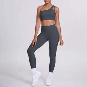 Detail of dark grey one-shoulder sports bra and high-waist yoga leggings set