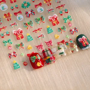 3D embossed Christmas nail stickers featuring festive red bows and green trees patterns