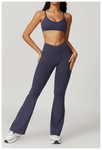 Close-up of high-waist criss-cross waistband on dark blue flare yoga pants