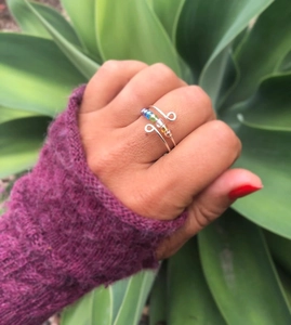 Detail of s925 silver fidget ring with colorful beads and handcrafted wire wrap