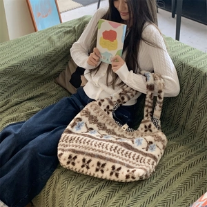 Close-up of plush hobo tote bag featuring ethnic jacquard pattern and checkered lining