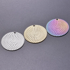 Detail of DIY stainless steel round pendants with spiral texture in gold, silver and rainbow