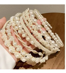 Detailed close-up of white pearl headbands with light gold metal base for girls