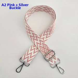 Close-up of pink and white chevron pattern thick woven adjustable bag strap with silver hooks
