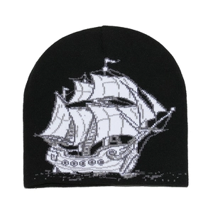 Bonnet en maille noire classique avec motif jacquard de voilier blanc pour l'hiver