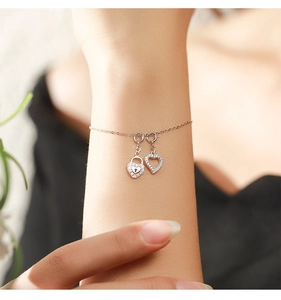 Close-up of S925 silver bracelet with heart lock and pave crystal hollow heart charms