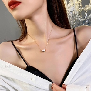 Elegant gold titanium steel hourglass pendant necklace worn on a model's collarbone