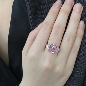 Sparkling pink rectangle zircon open ring with side stones on a silver-tone band
