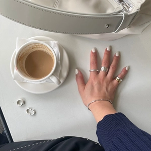 Minimalist 925 sterling silver jewelry set featuring irregular rings and cord bracelet