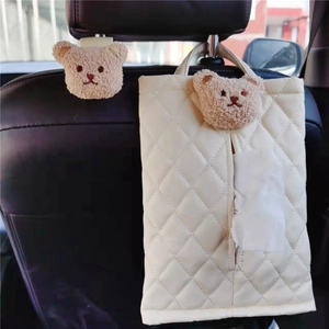 Quilted leather car seat back tissue holder with plush bear detail in cream white