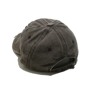 Detail of distressed grey baseball cap showing metal buckle and retro worn textures
