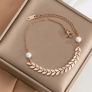 Détail du bracelet feuilles en or rose avec perles et poinçon K18 sur écrin brossé