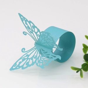 Detail of laser-cut butterfly napkin ring in turquoise blue with a pearlescent finish