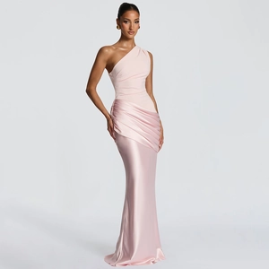 Close-up of the elegant light pink satin fabric and slim fit design of the evening gown