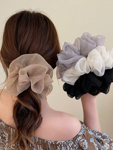 Detail view of large organza hair scrunchies in beige, grey, white and black colors