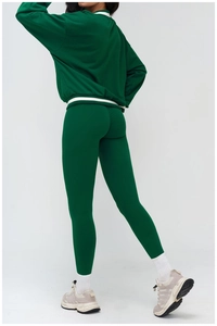 Rear view of women's dark green sports set showing high-waist yoga pants and sweatshirt