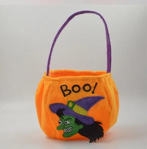 Detail of orange velvet Halloween candy bag with purple handle and Boo witch embroidery
