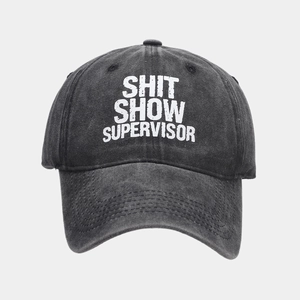 Close-up of washed cotton texture and Shit Show Supervisor print on charcoal baseball cap