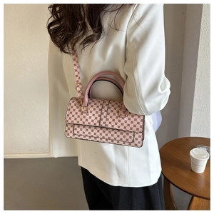 Chic pink textured satchel with retro patterns and gold-tone hardware detail